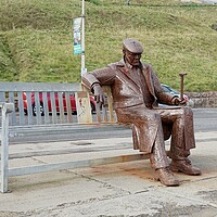 Buy canvas prints of Sculpture of Freddie Gilroy on bench Scarborough by Roy Hinchliffe
