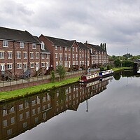 Buy canvas prints of Building reflections in Wakefield canal by Roy Hinchliffe