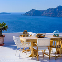 Buy canvas prints of Outdoor seats facing Aegean Sea in Oia, Santorini, Greece by Chun Ju Wu