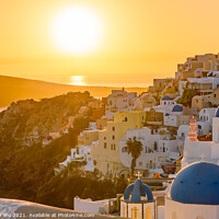 Buy canvas prints of Blue domed churches and traditional white houses facing Aegean Sea with warm sunset light in Oia, Santorini, Greece by Chun Ju Wu