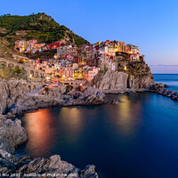 Buy canvas prints of Sunset and night view of Manarola, one of the five Mediterranean villages in Cinque Terre, Italy, famous for its colorful houses and harbor by Chun Ju Wu