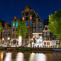 Buy canvas prints of Night view of buildings and boats along the canal in Amsterdam, Netherlands by Chun Ju Wu