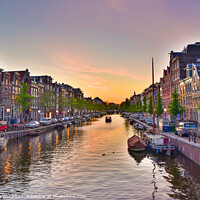 Buy canvas prints of Buildings and boats along the canal at sunset time in Amsterdam, Netherlands by Chun Ju Wu