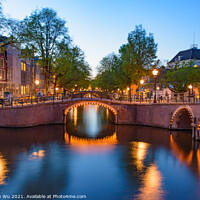 Buy canvas prints of Reflection of bridge along the canal at night in Amsterdam, Netherlands by Chun Ju Wu