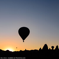 Buy canvas prints of Silhouette of flying hot air balloons and rock landscape at sunrise time in Goreme, Cappadocia, Turkey by Chun Ju Wu