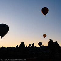 Buy canvas prints of Silhouette of flying hot air balloons and rock landscape at sunrise time in Goreme, Cappadocia, Turkey by Chun Ju Wu