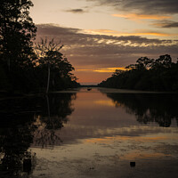 Buy canvas prints of A sunset over a body of water by Roger Worrall