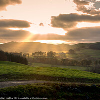 Buy canvas prints of Sun rays over Scottish hills by christian maltby