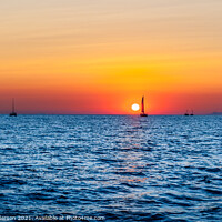 Buy canvas prints of Sunset off the coast  of Santorini.  by John Henderson