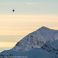 Buy canvas prints of Majestic Hot Air Balloon Soaring over Snowdon by John Henderson