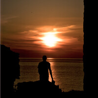 Buy canvas prints of Sunsetting with silhouette of a man by Jules D Truman