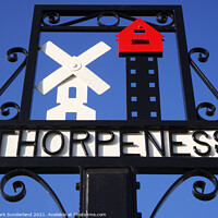 Buy canvas prints of Thorpeness Village Sign showing the Windmill and House in the Cl by Mark Sunderland