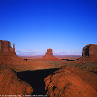 Buy canvas prints of The Mittens and Merrick Butte at Sunset Monument Valley by Mark Sunderland