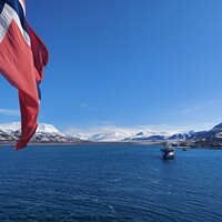 Buy canvas prints of Norwegian Winter: Majestic Mountain Flag in Blue Sky a view from svalbard and jan mayen by Anish Punchayil Sukumaran