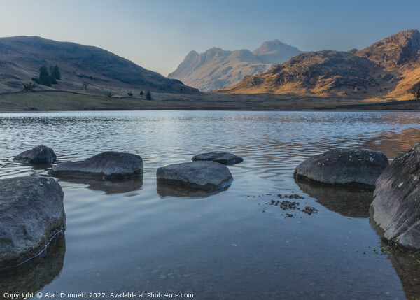 Blea Tarn as the sun sets on the Langdales Picture Board by Alan Dunnett