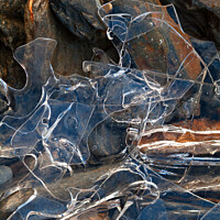 Buy canvas prints of Thin broken ice sheet fragments over rocks by Photimageon UK