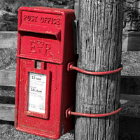 Buy canvas prints of An old red English post box fixed to a wooden post by Photimageon UK