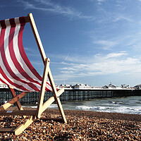 Buy canvas prints of Striped Deckchair on Brighton Beach, England by Neil Overy