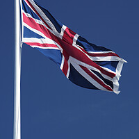 Buy canvas prints of Union Jack flying against blue sky by Neil Overy