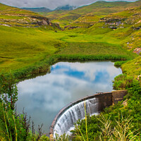 Buy canvas prints of View over Langtoon Dam nestled in a valley in the Golden Gate Highlands National Park beneath the distant Maluti mountains, Free State, South Africa.  by Adrian Turnbull-Kemp