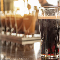 Buy canvas prints of Pint of stout beer in a pub in Dublin, Ireland by Delphimages Art