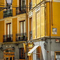 Buy canvas prints of Madrid old town yellow street, Spain by Delphimages Art