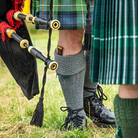 Buy canvas prints of Scottish bagpipers during Highland Games by Delphimages Art