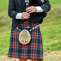 Buy canvas prints of Scottish bagpiper in traditional kilt in the Highl by Delphimages Art