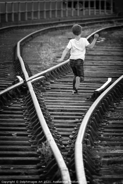 Boy running on old railway tracks in Bristol Picture Board by Delphimages Art