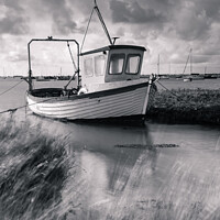Buy canvas prints of Fishing boat in salt marsh by Martin Tosh