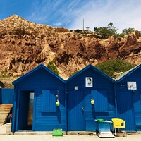 Buy canvas prints of Colourful Beach Huts on Algarves Golden Cliffs by Chris Mc Manus