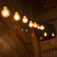 Buy canvas prints of Light bulbs in trendy restaurant by Elijah Lovkoff