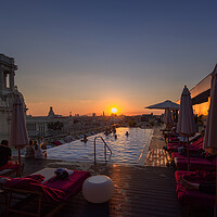 Buy canvas prints of A scenic panoramic view of Havana Historic Center (Havana Vieja) and Capitolio at sunset from the roof terrace of the luxury hotel with swimming pool and restaurant by Elijah Lovkoff