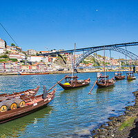 Buy canvas prints of Famousboats providing carrying Porto wine in barrels on Rio Douro by Elijah Lovkoff