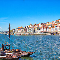 Buy canvas prints of Famous colorful boats providing tours along banks of Rio Douro by Elijah Lovkoff