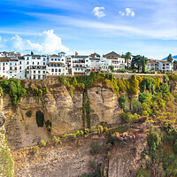 Buy canvas prints of Famous Ronda restaurants and colonial houses overlooking the scenic gorge and the Puente Nuevo bridge by Elijah Lovkoff