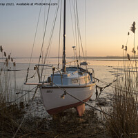 Buy canvas prints of Yacht at moorings winter sunset, River Deben, Ramsholt, Suffolk, England, UK by Ian Murray
