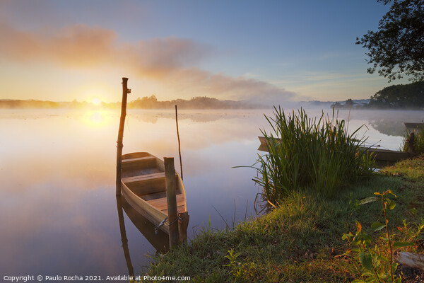 Small boat at sunrise by the lake  Picture Board by Paulo Rocha