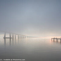 Buy canvas prints of Long bridge over tagus river in Lisbon at sunrise with fog by Paulo Rocha