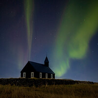 Buy canvas prints of Northern Lights over The Black Church in Budir, Iceland by Paulo Rocha