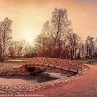 Buy canvas prints of Sunset over wooden bridge in city park by Maria Vonotna