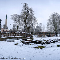 Buy canvas prints of Snowy park with footbridge in winter by Maria Vonotna