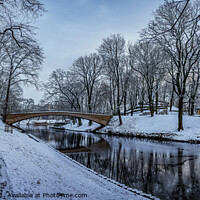 Buy canvas prints of Winter park with stone bridge and canal by Maria Vonotna