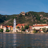 Buy canvas prints of Duernstein Cityscape with Blue Abbey Church Tower and Kuenringer by Dietmar Rauscher