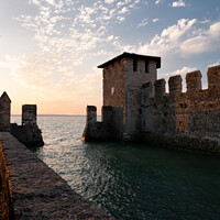 Buy canvas prints of Scaligero Castle in Sirmione on Lake Garda, Italy at Sunrise by Dietmar Rauscher