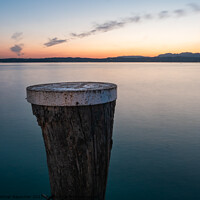 Buy canvas prints of Lake Garda Sunset with Mooring Pole in Sirmione by Dietmar Rauscher