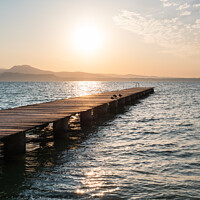 Buy canvas prints of Lake Garda Jetty at Sunrise at Sirmione by Dietmar Rauscher