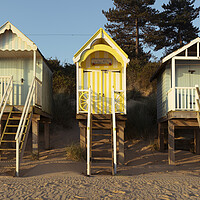 Buy canvas prints of Colorful wells next the sea beach huts England by Sonny Ryse