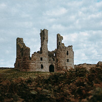 Buy canvas prints of Dunstanburgh Castle in Winter by Dan Beegan