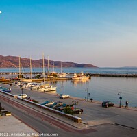 Buy canvas prints of Golden Hour at Karystos Harbour by Margaret Ryan